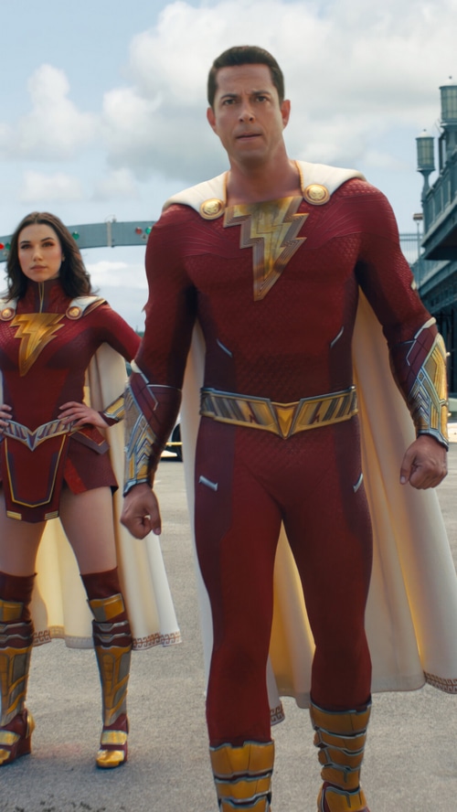 Shazam and a female Shazam stand outdoors