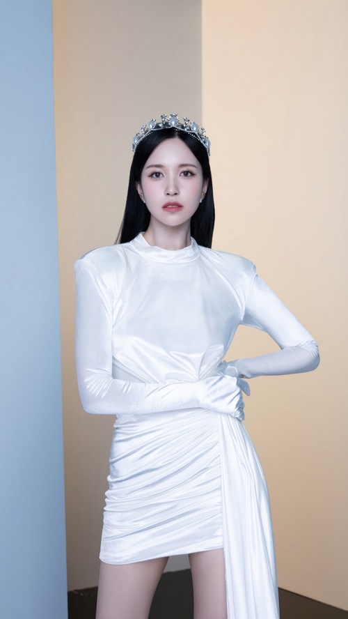 Mina wearing a crown and white dress