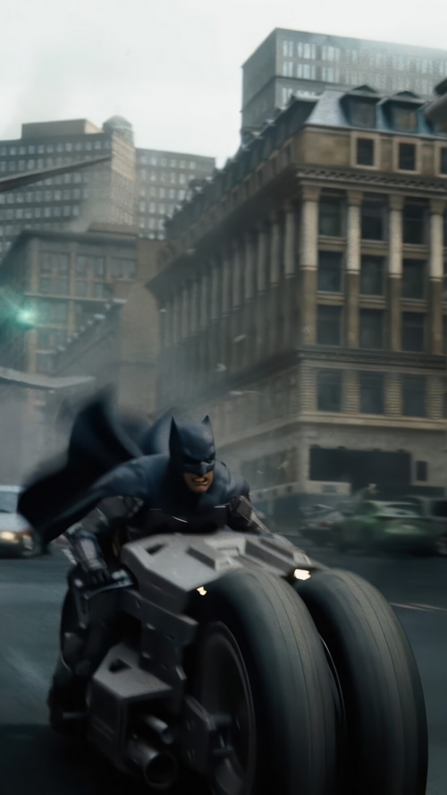 Batman riding the Batpod in a city