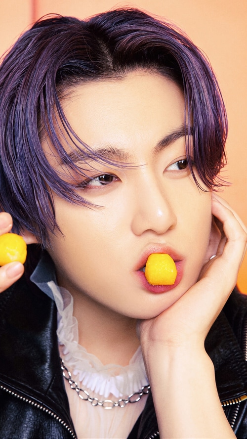 Jungkook of BTS with yellow candy