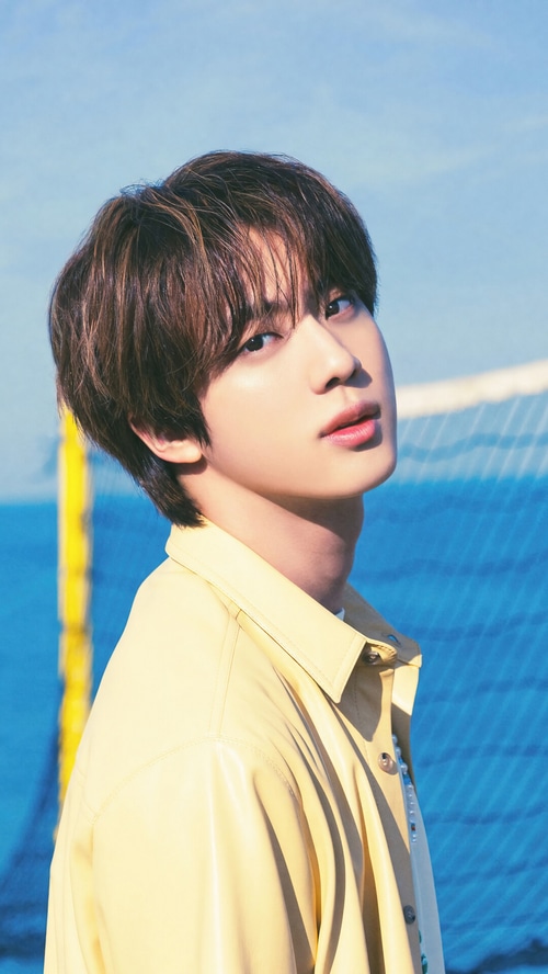 Jin from BTS in a yellow jacket