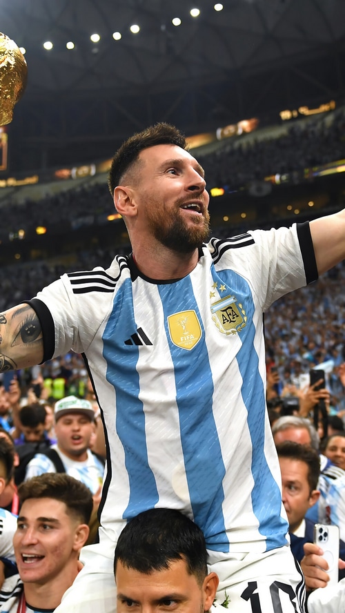 Lionel Messi celebrates with the FIFA World Cup trophy