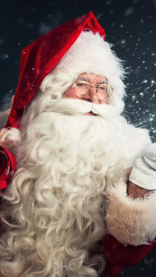 Santa Claus with a white beard and red hat