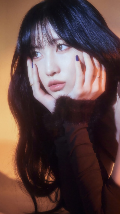 Momo from TWICE with dark hair and fur collar