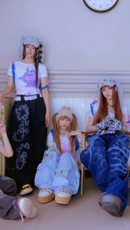 NewJeans members posing in stylish outfits