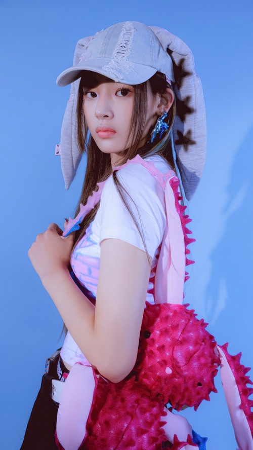 Minji from NewJeans wearing a bunny hat