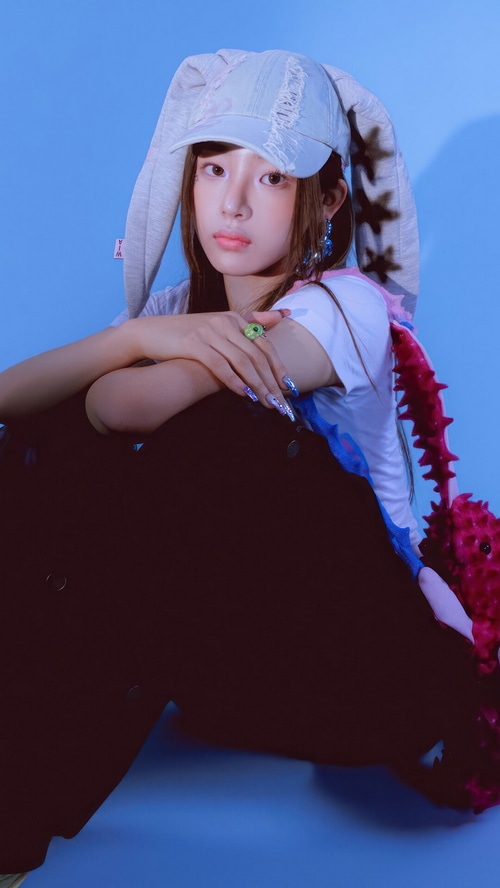 Minji from NewJeans wearing a bunny hat