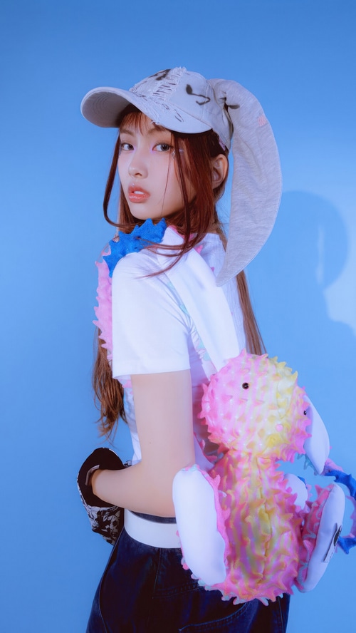 NewJeans Hyein wearing a bunny hat and holding a plush toy