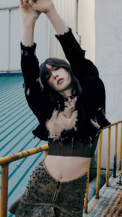 Taeyeon in a black ripped sweater and studded skirt