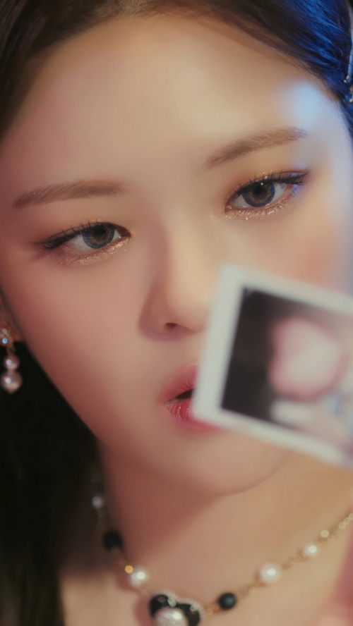 Jeongyeon of TWICE holding a polaroid photo