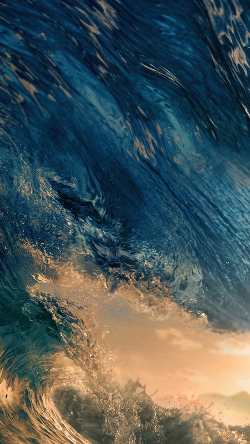 Close-up of a powerful ocean wave at sunset