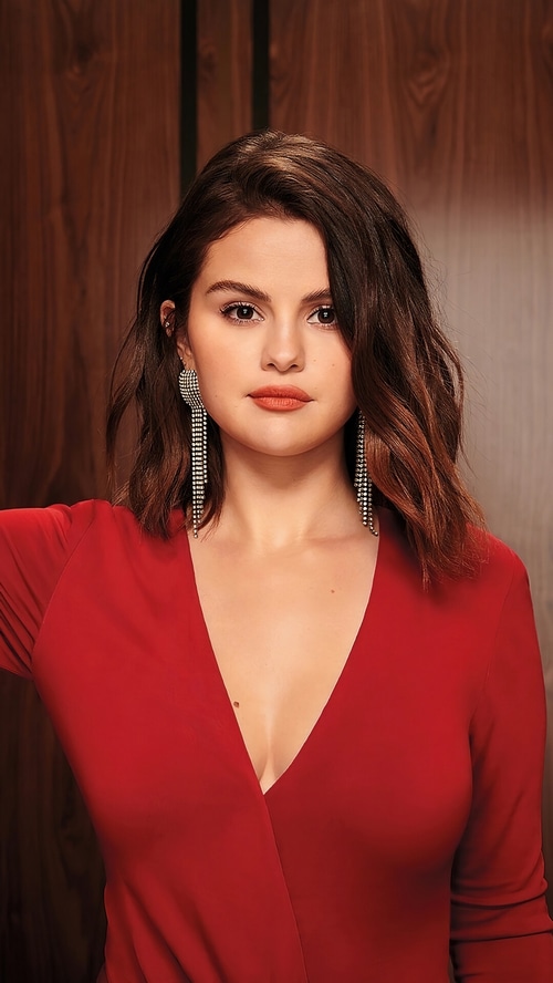 Selena Gomez in a red dress with long earrings