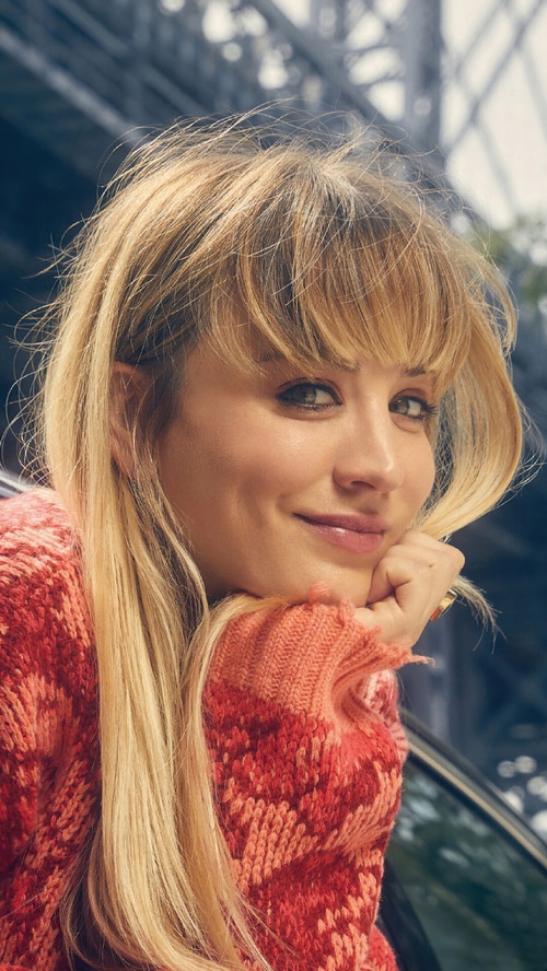 Kaley Cuoco in a red and orange patterned sweater