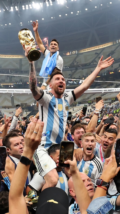 Lionel Messi and Lautaro Martinez celebrate with the World Cup trophy
