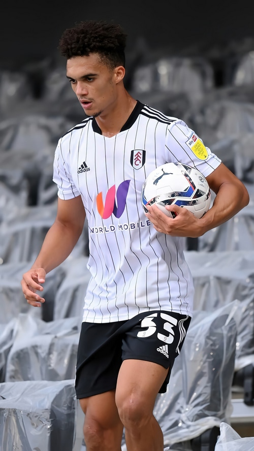 Fulham player Antonee Robinson holding a soccer ball
