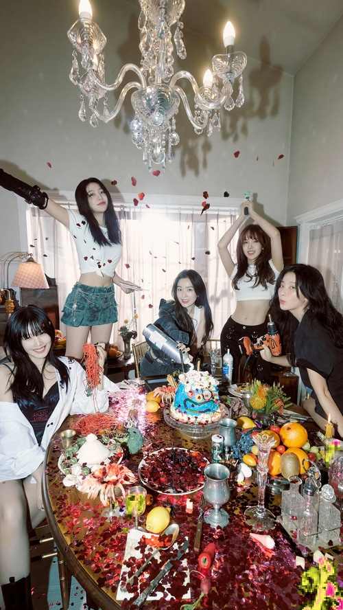 Red Velvet members celebrate with a cake and confetti