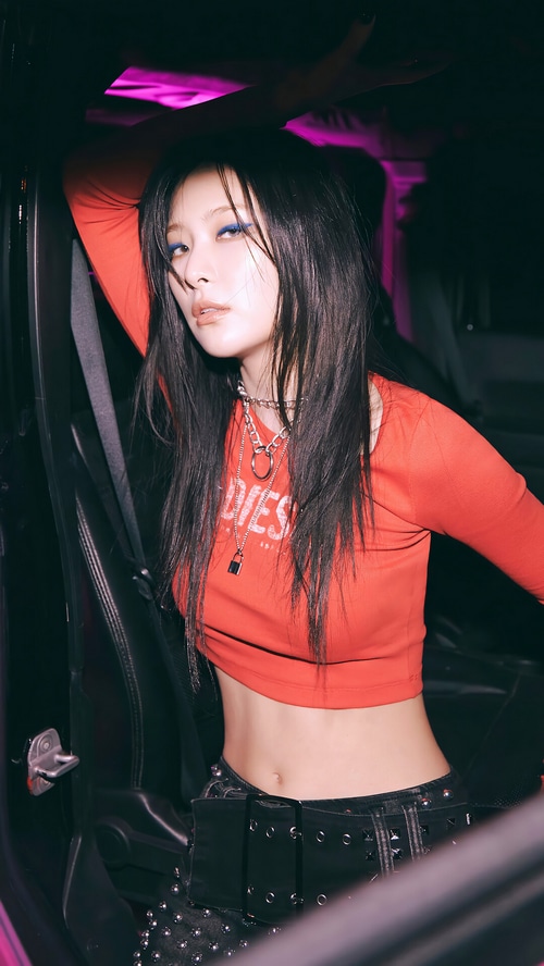 Seulgi in a red top and black studded pants