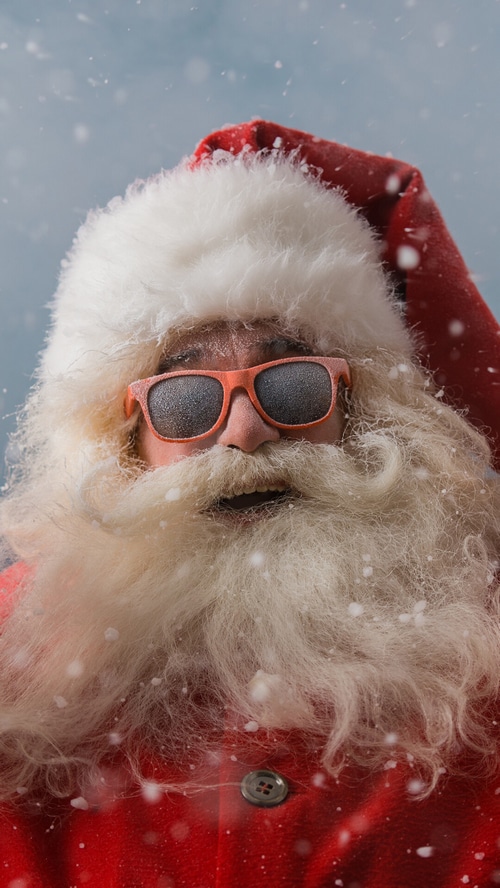 Santa Claus wearing sunglasses in the snow