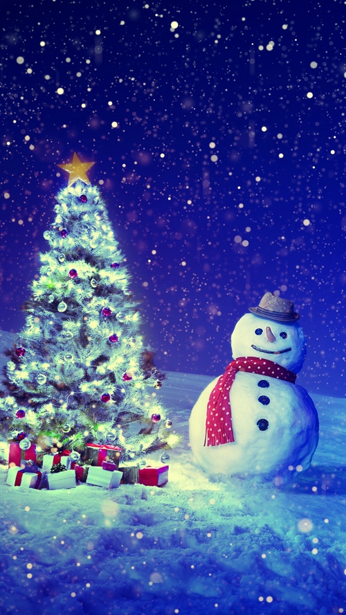 Christmas tree with gifts and a snowman in the snow