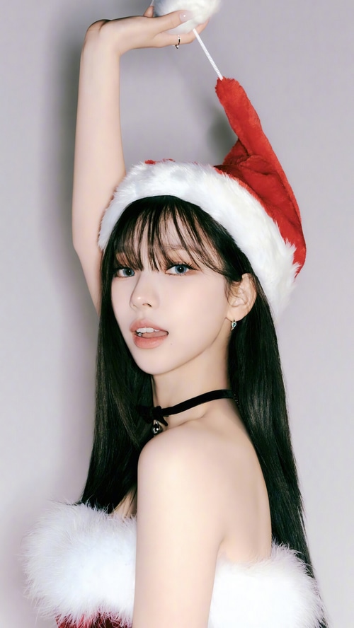 Karina wearing a Santa hat and festive outfit