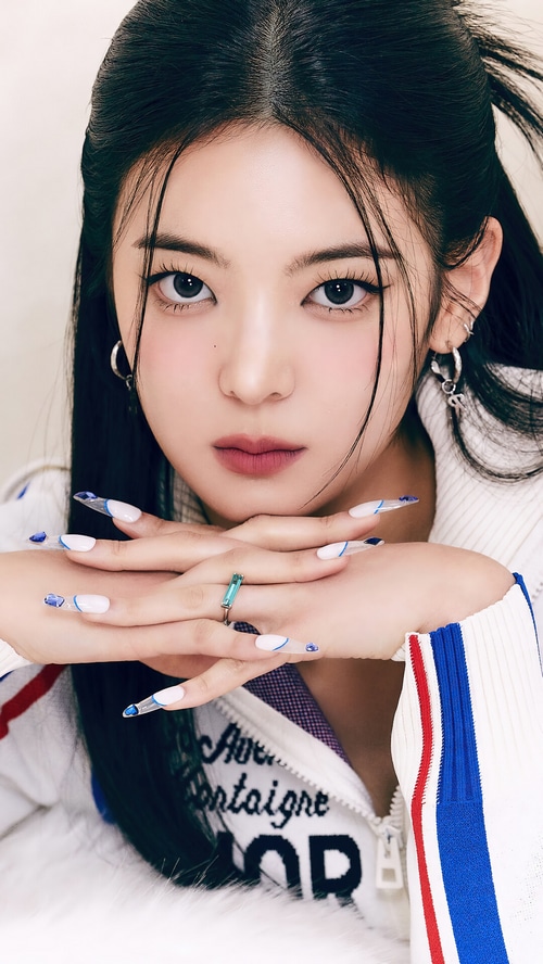 Lia from ITZY with long dark hair and white nails