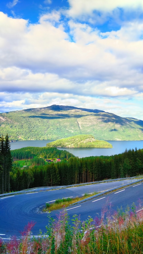 Curvy mountain road overlooking a lake and island