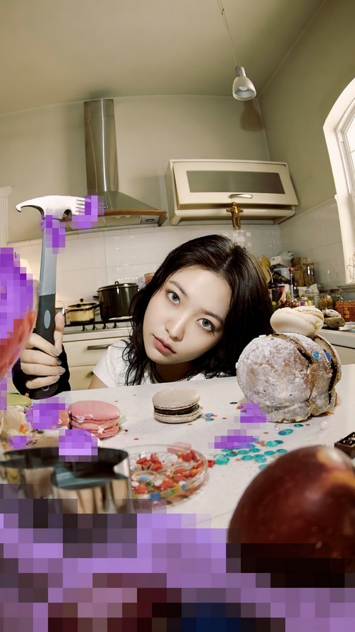 Yeri holding a kitchen utensil in a messy kitchen