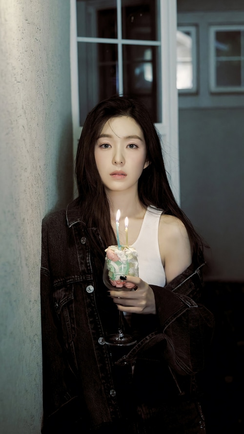Irene holding a birthday cake with candles
