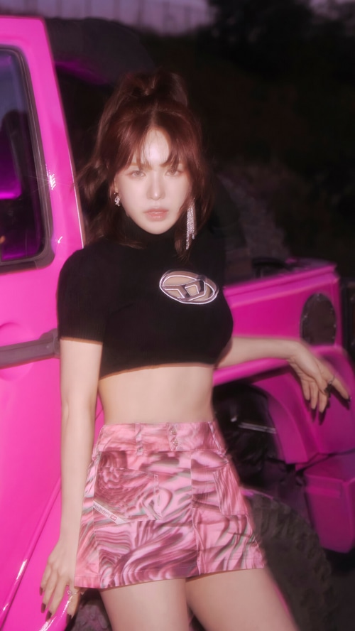 Wendy of Red Velvet posing by a pink car