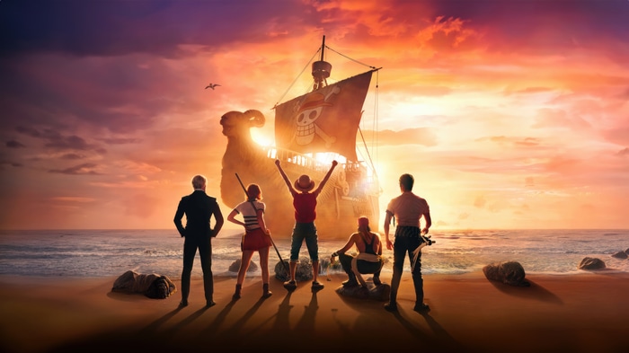 One Piece characters on a beach with a ship