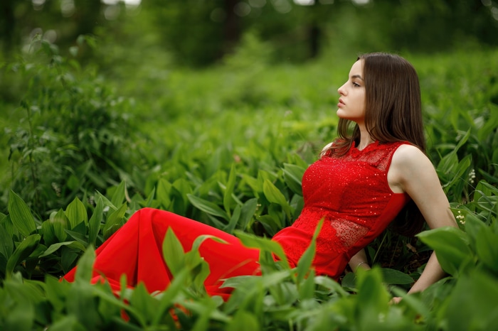 Girl in a red dress in the grass 4K