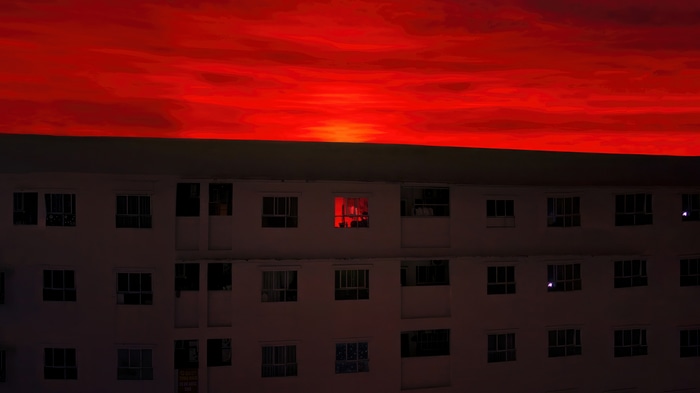 Digital art of a building against a red sky