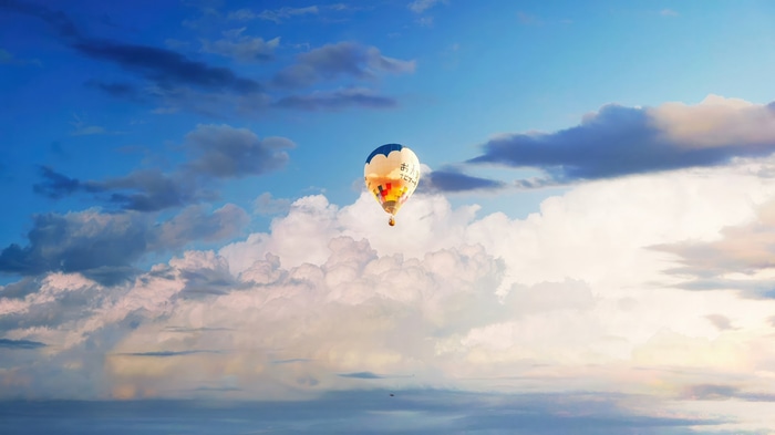 Hot air balloon in the sky with clouds