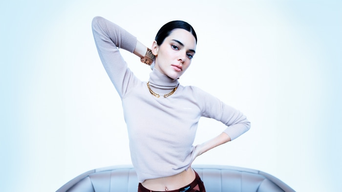 Kendall Jenner in a beige turtleneck and gold necklace