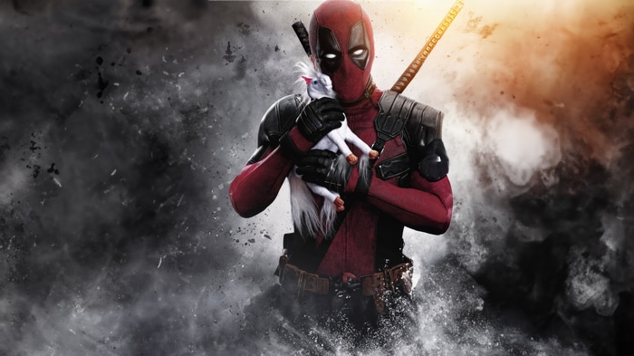 Deadpool holding a unicorn toy