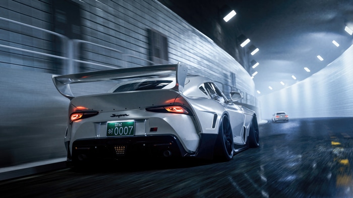 White Toyota Supra with large spoiler in tunnel