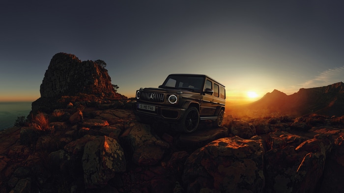 Mercedes G Class SUV on rocky mountain at sunset