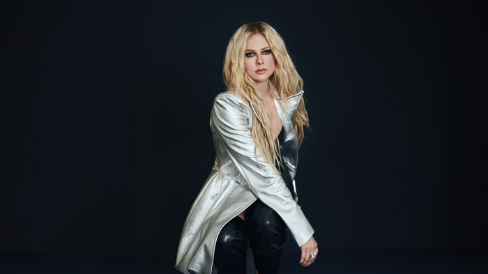 Avril Lavigne in a silver jacket and black pants