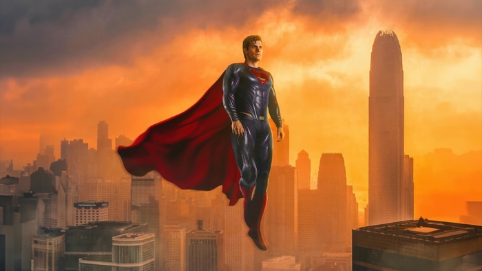 Superman flying over a city at sunset