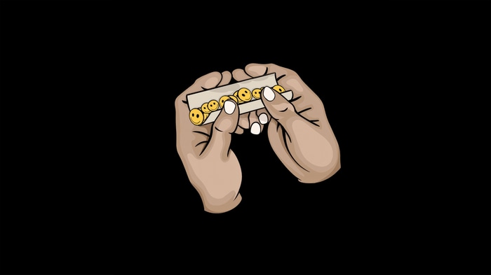Hands rolling paper with smiley faces