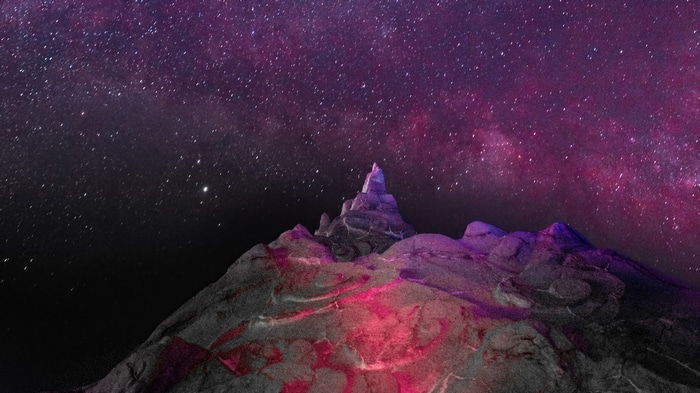Mountain peak under a starry night sky
