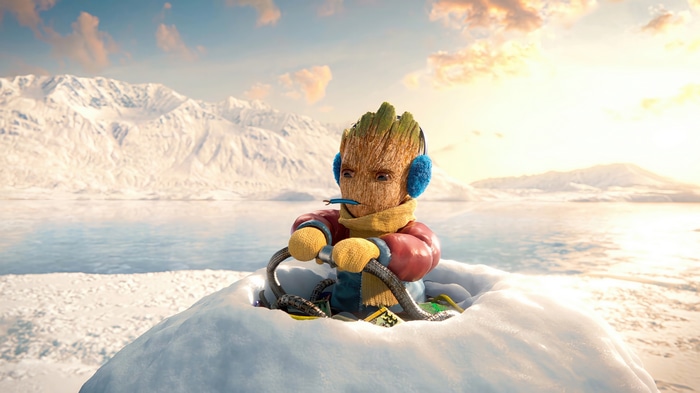 Baby Groot in winter gear on a snowy landscape