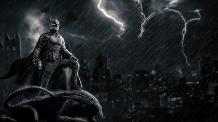 Batman standing on a gargoyle in the rain with lightning