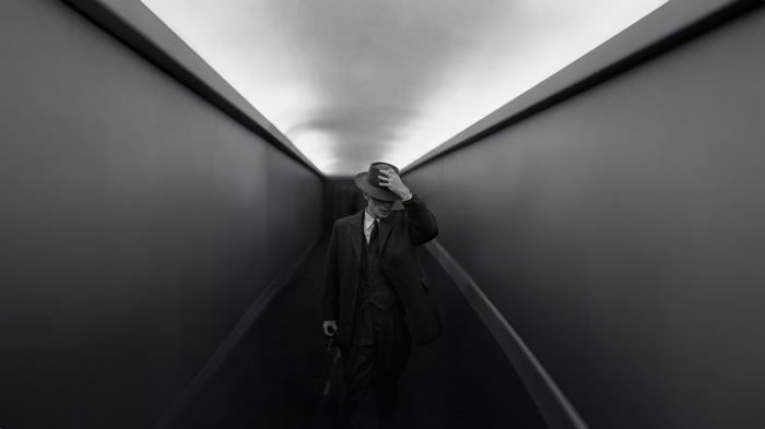 Oppenheimer in a dark hallway