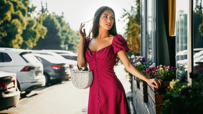 Model in a red dress with a handbag