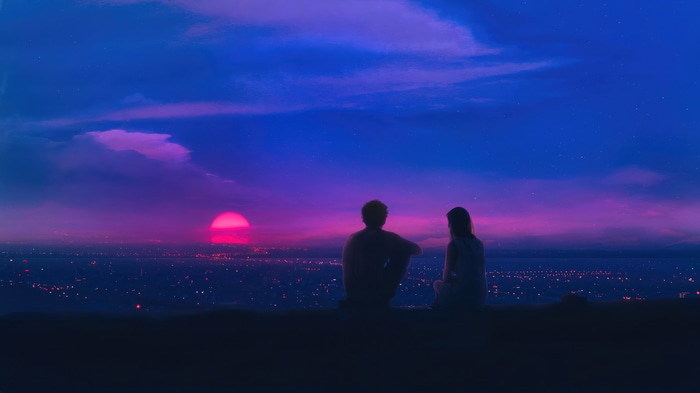 Couple watching a pink sunset over a city