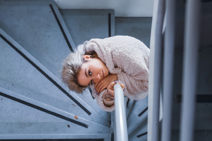 Model with blonde hair on stairs