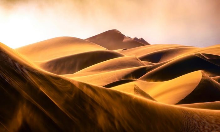 Golden sand dunes under a hazy sky 4K