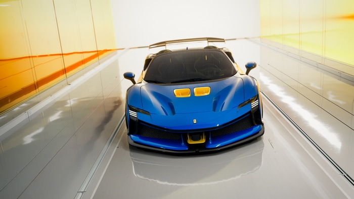 Blue Ferrari SF90 XX Spider in a tunnel