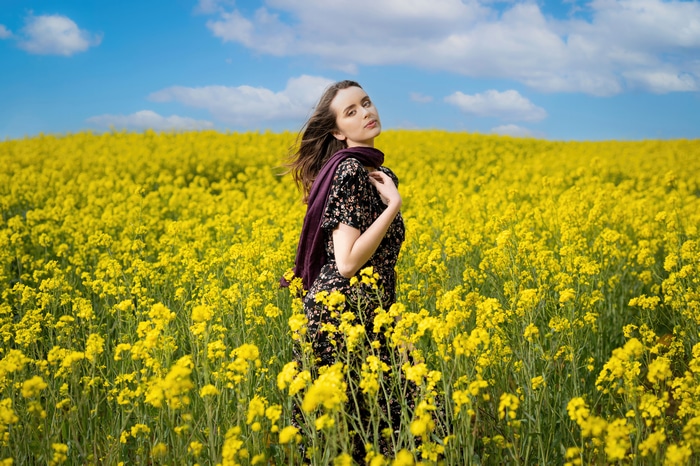 Woman in a field of yellow flowers